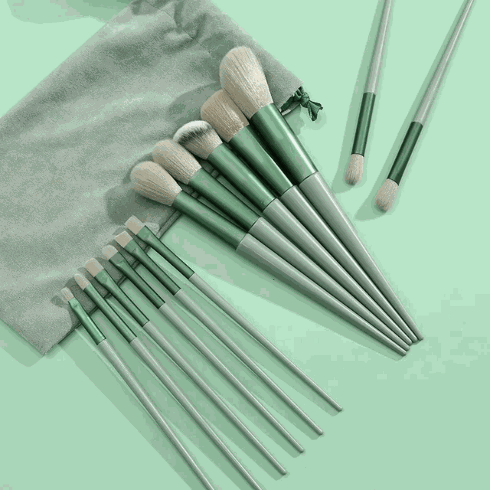 13 PCS green makeup brushes set including eye shadow and foundation brushes displayed on a soft background.