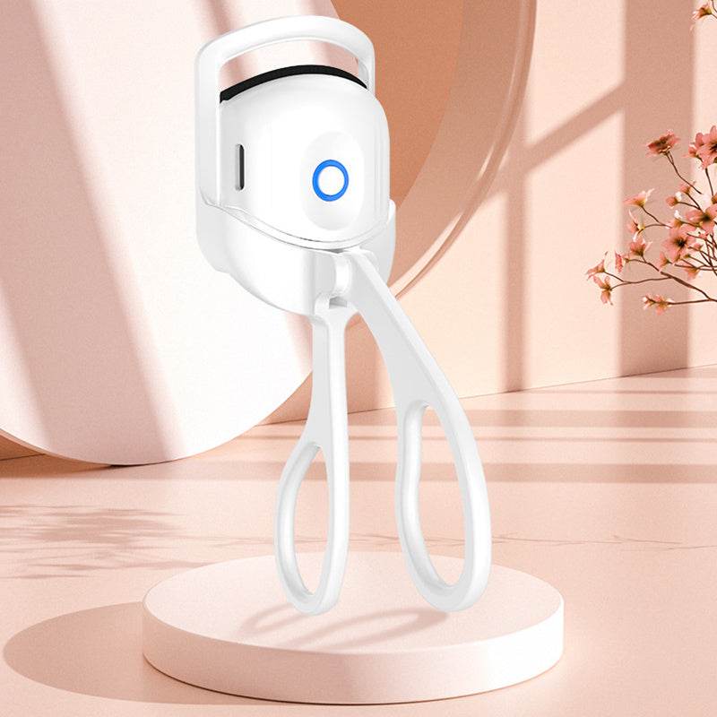 Portable electric heated eyelash curler, ergonomic design, compact size, rechargeable, dual temperature settings.