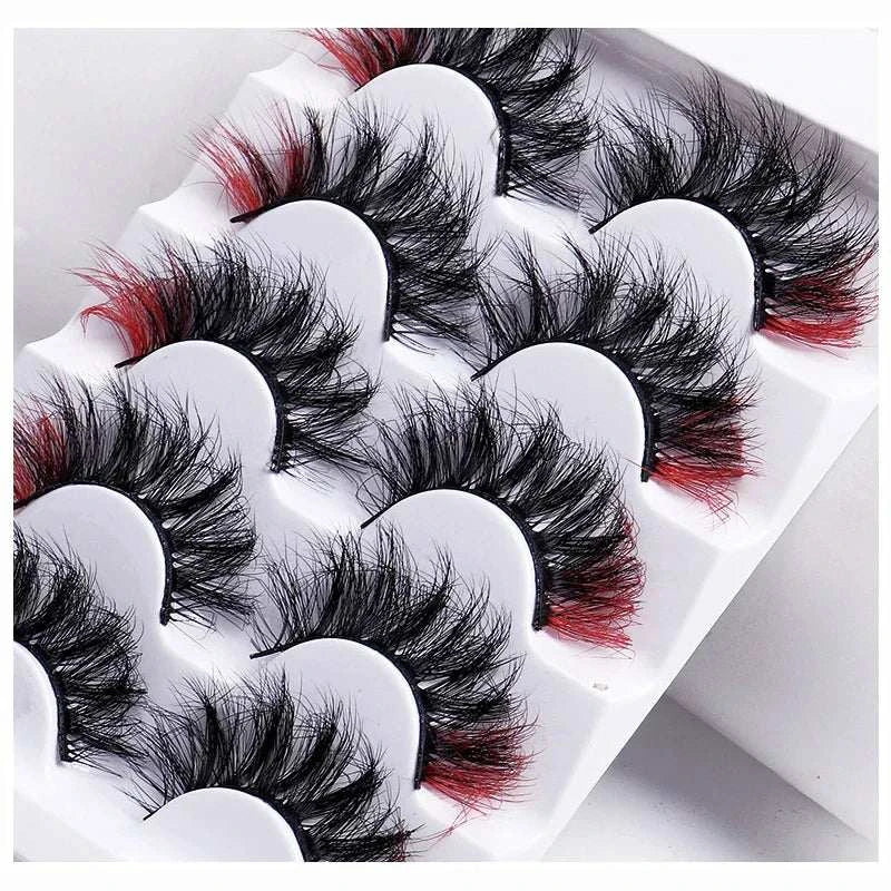 7 pairs of color volume fake eyelashes in a white tray with red and black mink lashes for a glamorous look.