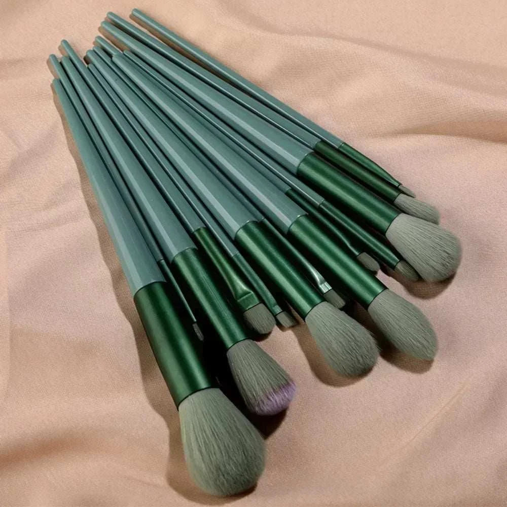 13 PCS green makeup brushes set including eye shadow and foundation brushes displayed on a soft background.