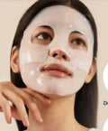 Woman applying skin collagen film for a revitalized, youthful complexion.